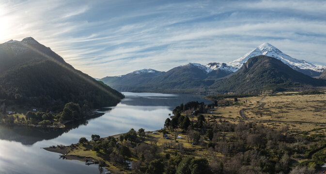 Majestic Panoramic View of Lake Huechulafquen and Snow-Capped Lanin Volcano with Dramatic Sun Rays. Patagonia, Argentina