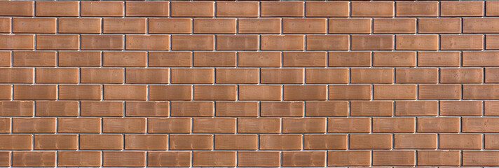 Brown brick wall with textured masonry pattern