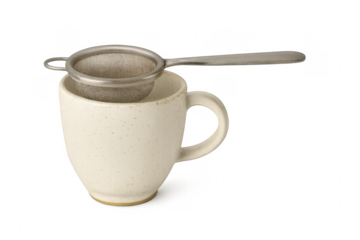 Ceramic mug and tea strainer ready for making hot drink