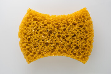 Close-up of a vibrant yellow kitchen sponge with texture