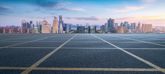 Urban road with modern city skyline in the background