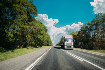 Truck On Country Road. Tractor Unit, Prime Mover, Traction Unit In Motion On Countryside Road In Europe. Business Transportation And Trucking Industry Concept
