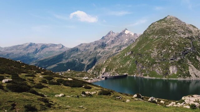 Drone approaching Montespluga Dam and Lake in the Italian Alps