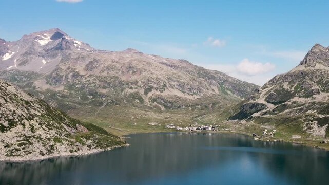 Drone approaching Montespluga town with surrounding mountains - Italian Alps