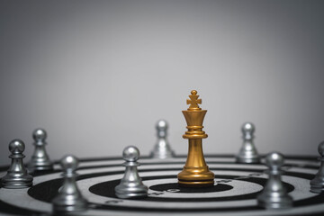Golden chess king piece standing on target with pawns around, symbolizing leadership, strategy, success, and focus. Great for business, planning, and goal achievement themes.