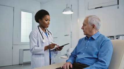 female doctor showing medical results on tablet to senior male patient, healthcare consultation, modern clinic interior, professional medical examination, patient care - Powered by Adobe