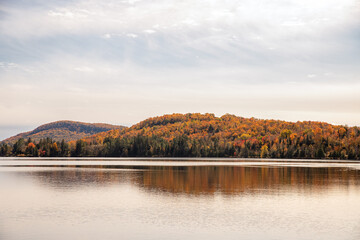 Autumn forest on the shore of the lake. Beautiful autumn landscape. Quebec, Canada.	