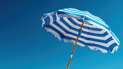 Striped Blue And White Beach Umbrella Set Against Clear Sky On Sunny