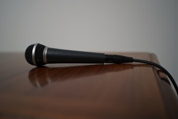 Elegant Close-Up of a Microphone Resting on a Polished Surface with a Soft Background for Enhanced Focus