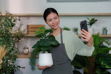 Indoor Gardening. Woman taking selfie with potted plant.