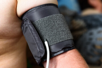 Measuring blood pressure with an automatic blood pressure monitor at home.