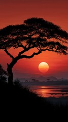 Breathtaking Sunset Over a Tranquil Landscape with Silhouette of a Leafy Tree against a Vibrant Orange and Red Sky