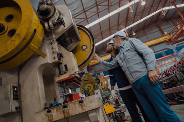 Engineers and staff are inspecting systems and components in a metal sheet and metal roofing manufacturing plant.