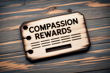 Compassion rewards concept on wood background featuring burned effect