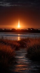 Stunning Sunset Over Calm Waters with Fiery Sky and Illuminated Launch in Background Surrounded by Grassy Path and Reflections on Water Surface