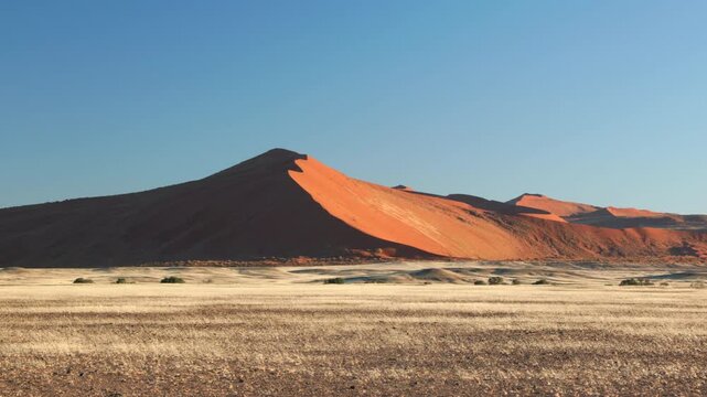a panning clip of a sand dune at sunrise in sossusvlei of namibia, africa