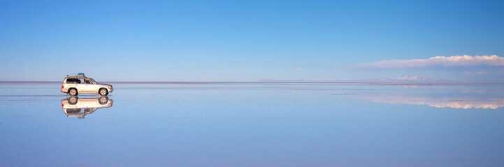 Mirror effect and reflections of a car in Salar de Uyuni (Uyuni salt flats), Potosi panorama,...