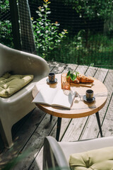 Enjoying a delicious breakfast with coffee and croissant on a cafe terrace