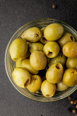 Green olives pickled seedless natural product tasty snack fresh delicious gourmet food background on the table rustic top view copy space