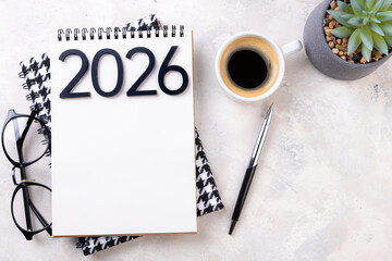 New year goals 2026 on desk. 2026 resolutions list with notebook, plant on table. Resolutions, plan, goals, action, checklist, idea concept. New Year 2026 resolutions, copy space