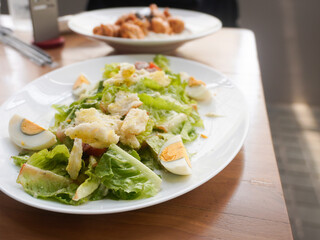 homemade Caesar Salad with crisp romaine lettuce, eggs, smoked beef, crunchy croutons, parmesan cheese, and a light Caesar dressing