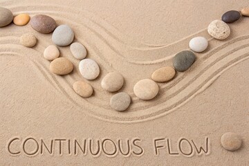 Flatlay of Meticulously Arranged Smooth Natural Pebbles in Sand