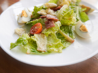 homemade Caesar Salad with crisp romaine lettuce, eggs, smoked beef, crunchy croutons, parmesan cheese, and a light Caesar dressing