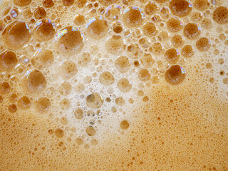 Coffee foam , creamy coffee foam, rich, frothy surface, freshly brewed cup of hot Americano. Top view of Espresso foam closeup. Creamy coffee macro shot
