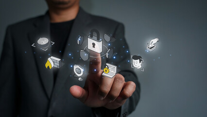Businessman touching a padlock icon protecting business data. Cybersecurity, data protection, and digital security technology concepts.