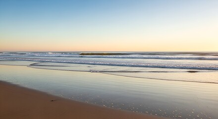 Serene Beach at Sunrise: Waves Kissing the Sandy Shoreline
