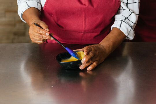 Pastry chef whisking ingredients in cooking class