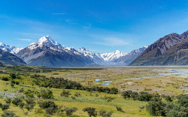 Majestic snow capped mountains under a clear blue sky