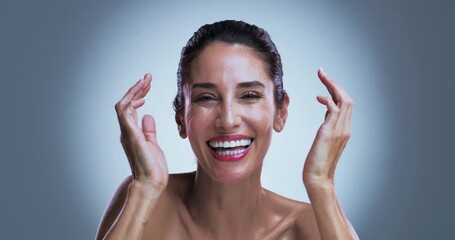 Face, woman or laughing in studio with skincare for wellness, collagen or anti aging benefits. Mature, happy or female person with spotlight for beauty, smooth skin or dermatology on gray background.