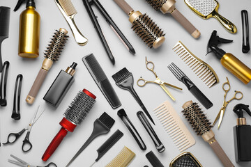Different hair styling tools on white background, flat lay