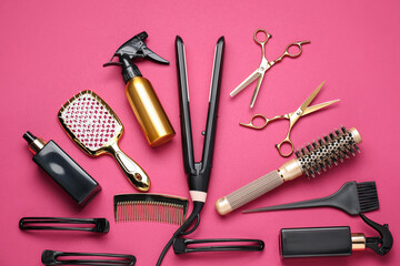 Different hair styling tools on pink background, flat lay