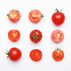 Whole and cut red tomatoes on white background, flat lay