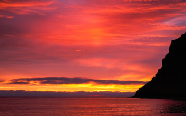 Fiery sunset paints the sky over the ocean