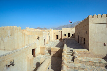 Ancient fort courtyard under a clear blue sky