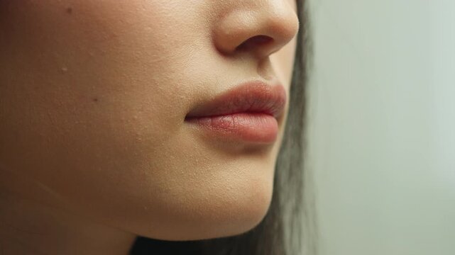 Closeup lovely seductive female plump lips kissing girl kiss in studio unknown unrecognizable Asian woman mouth love affection concept flirting lipstick cosmetology dermatology beauty filler injection