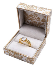 Elegant gold ring with diamond placed inside decorative jewelry box with floral patterns and plush interior for special occasions