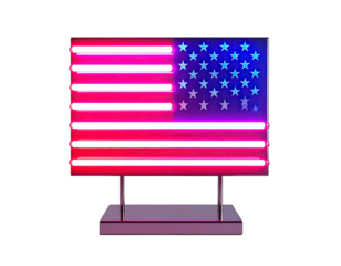 A neon sign depicting the US flag, glowing red, white, and blue, mounted on a stand