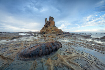 Stormy coastal landscape with eroded cliffs, rock formations and tidal pools, Victoria, Australia