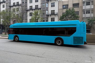 A blue charter bus on a city street in the summer