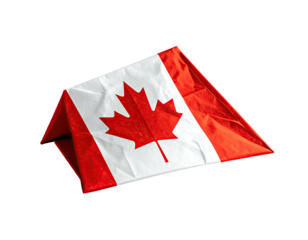 A small, folded textile piece showing a maple leaf design with a red and white color scheme