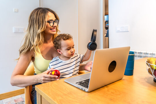 Mother and son enjoying time together with laptop and headphones