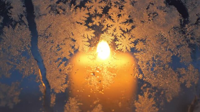 A cinematic frosted window loop with glowing candlelight behind the glass, perfect for cozy Christmas backgrounds and festive visuals