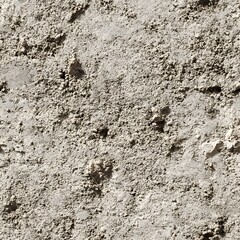 A close up shows the rough texture of a concrete surface with visible cracks and uneven, grainy details.