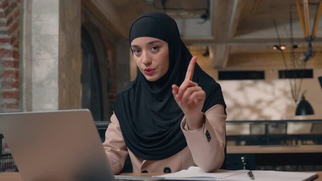 Arabian business woman in hijab businesswoman shking finger no laptop using negative Islamic female girl Muslim worker office manager working online computer browsing waving not never gesture refuse