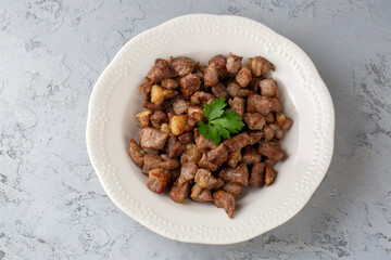 Muslims Traditional Sacrifice holiday food lamb, Turkish roasted meat in copper pot on table top. Turkish Kavurma. (Turkish name; Kurban kavurma)