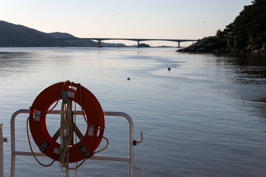 idyllic seascape with a boat and bridge